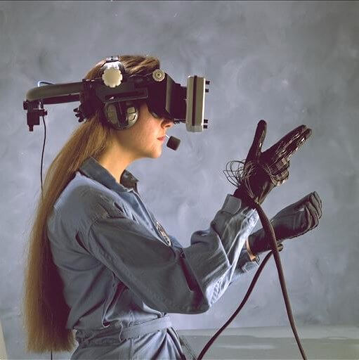 A woman wearing virtual reality helmet and a glove